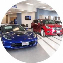 A blue sports car next to a red SUV in a car dealership lobby