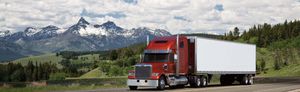 Front of a Freightliner Coronado SD in front of a mountain