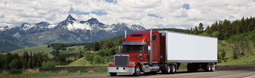 Front of a Freightliner Coronado SD in front of a mountain