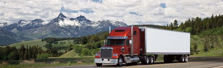 Front of a Freightliner Coronado SD in front of a mountain