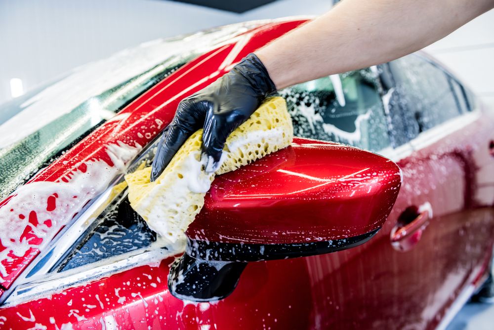 Close up of suds on a red car
