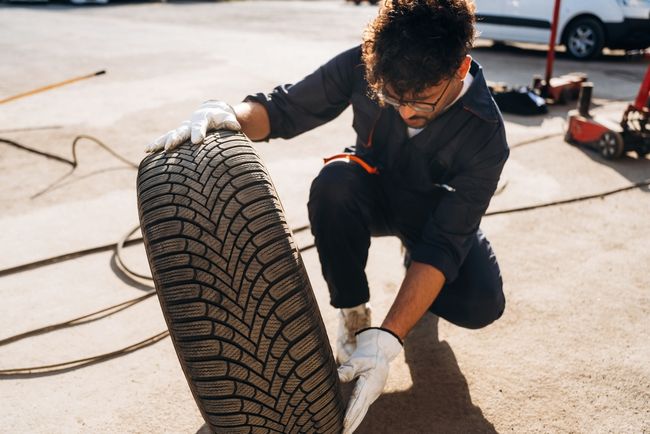 Mechanic inspects a tire