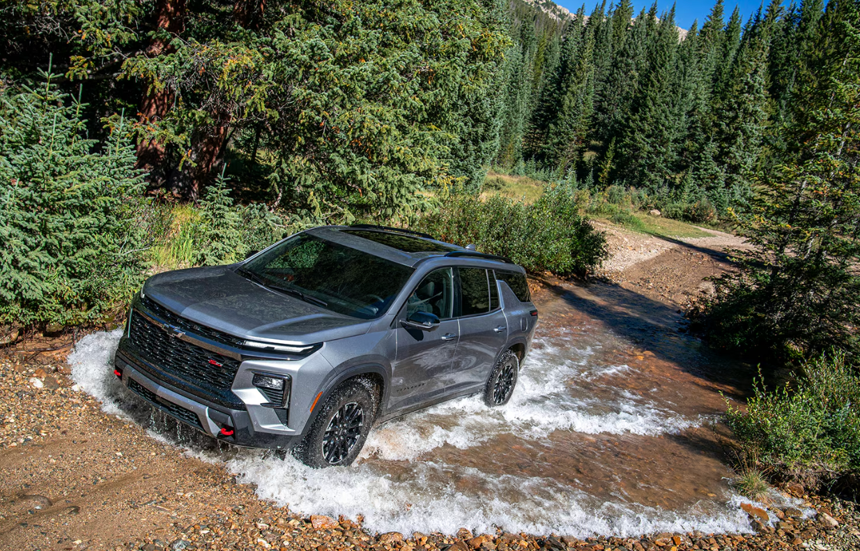 A view of a Chevrolet Traverse from above, the SUV is splashing through water