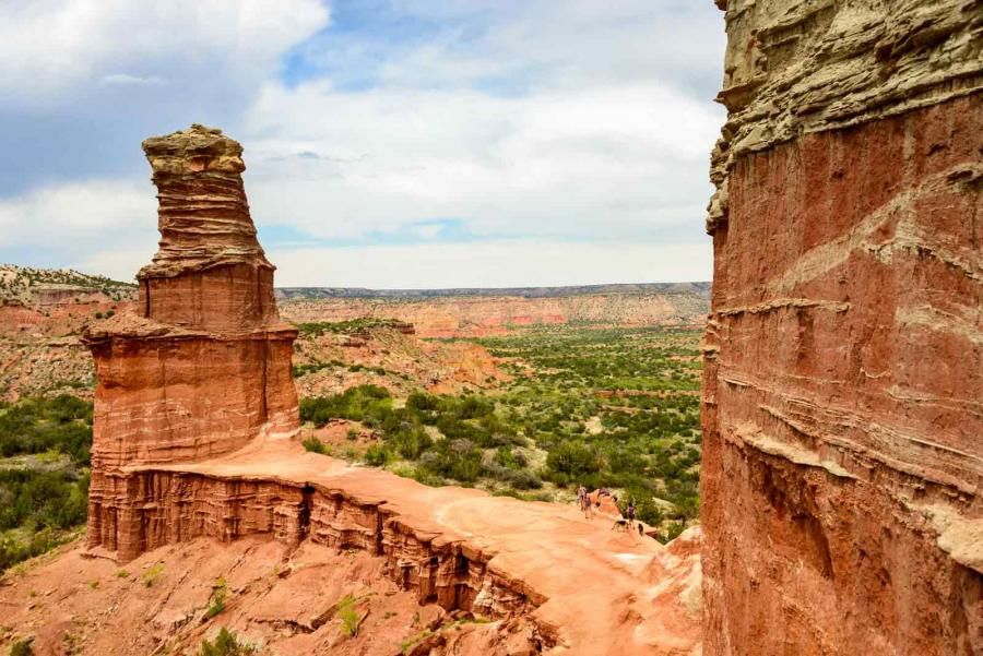 Red rocks and green trees in the distance in Palo Duro Canyon State Park, Texas