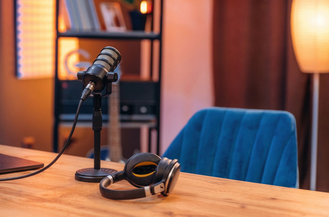 A microphone sits on a table in front of an empty chair