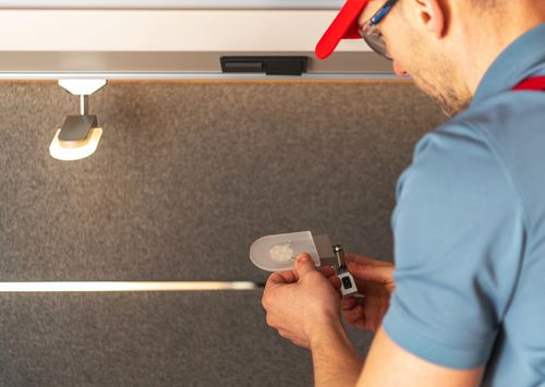 Person replacing an interior light inside an RV
