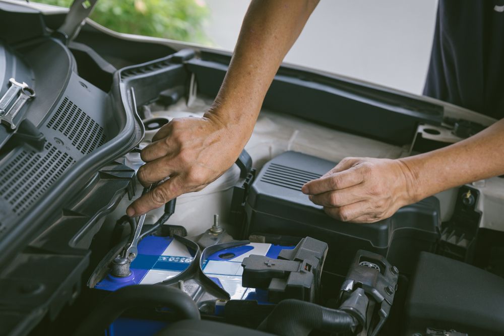 Close up of someone changing a car battery