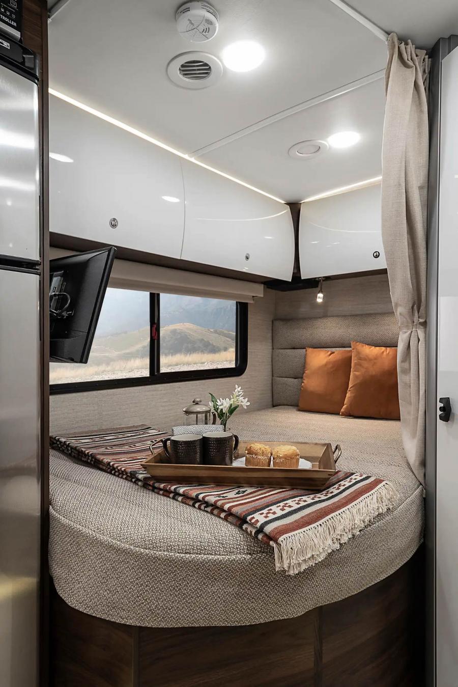 Raised bed space inside an RV with a curtain dividing it