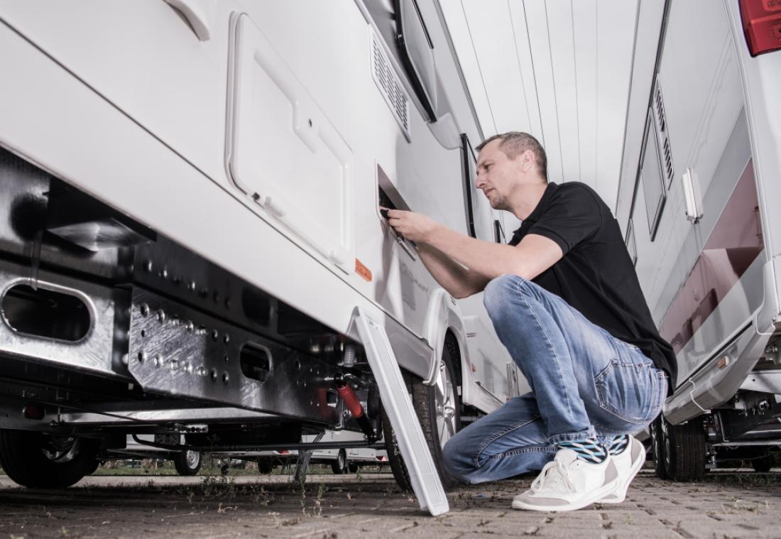 Inspecting the refrigerator compartment from the outside of an RV