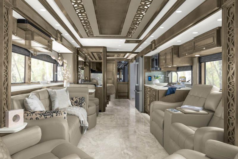 Living space with kitchen and bedroom beyond it inside the 2023 Newmar Essex Class A RV