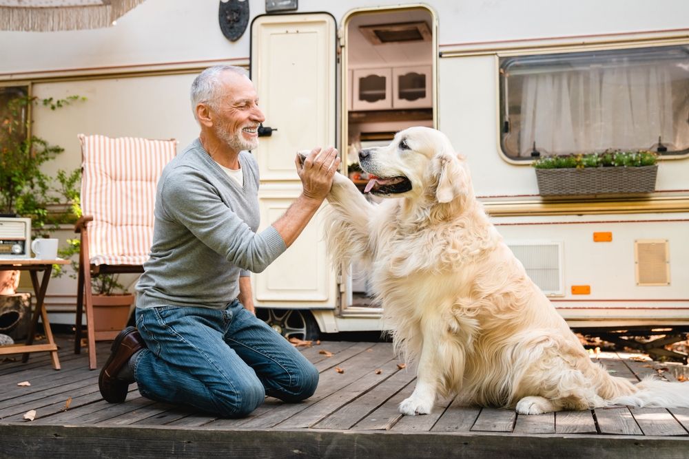 Man with a dog outside an RV