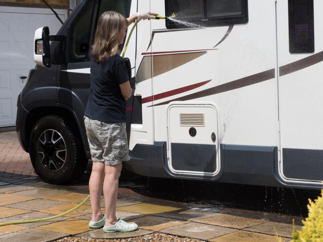 Person cleaning the exterior of an RV