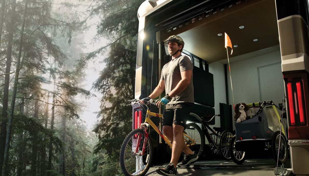 Man on a bike in the back of a toy hauler