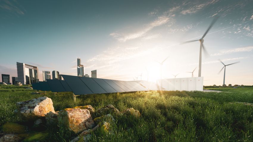 Wind and solar power in front of a cityscape