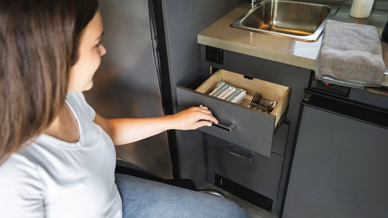 Woman uses storage inside an RV