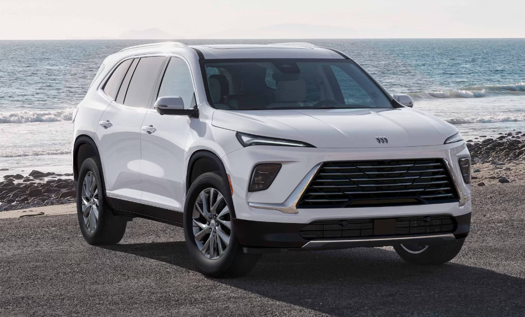 A white Buick Enclave parked on a beach