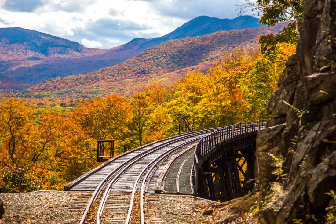 Train bridge through autumn foliage in New Hampshire