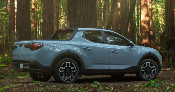 A light blue Hyundai Santa Cruz in the woods