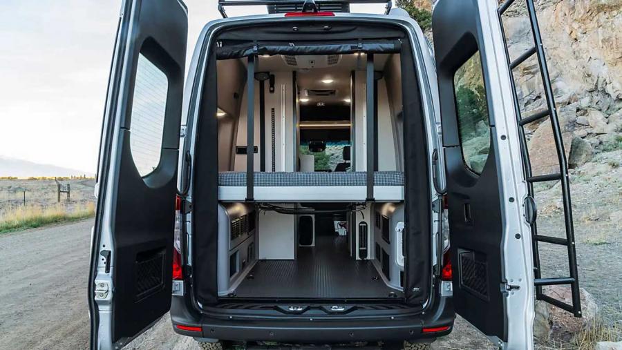 Rear doors of Winnebago Revel campervan open to reveal convertible eurolift bed