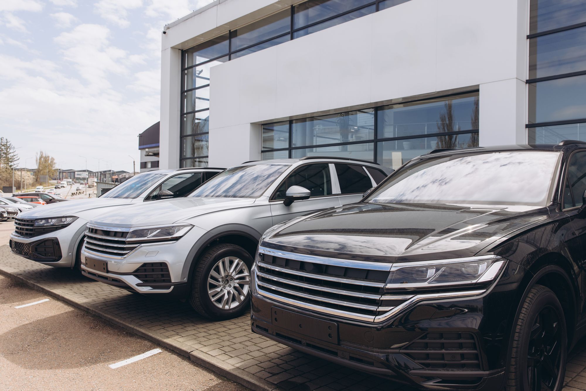 Three SUVS side by side in a parking lot