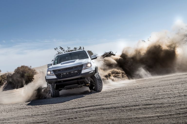 A truck off-roads in the sand