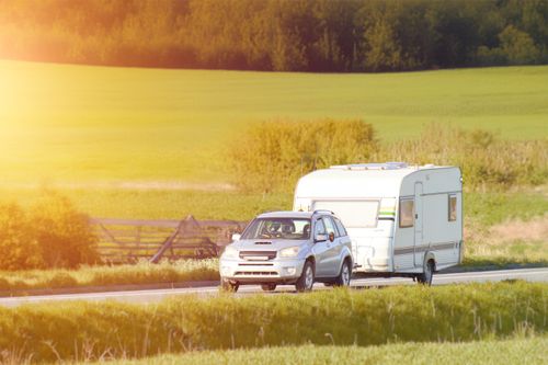 An SUV tows a trailer