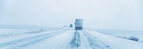Trucks on icy snow packed road