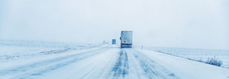 Trucks on icy snow packed road