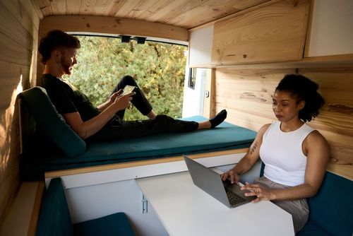 Couple enjoying devices inside an RV