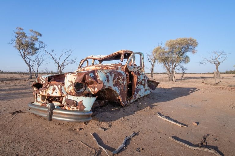 Rusted car in a desert