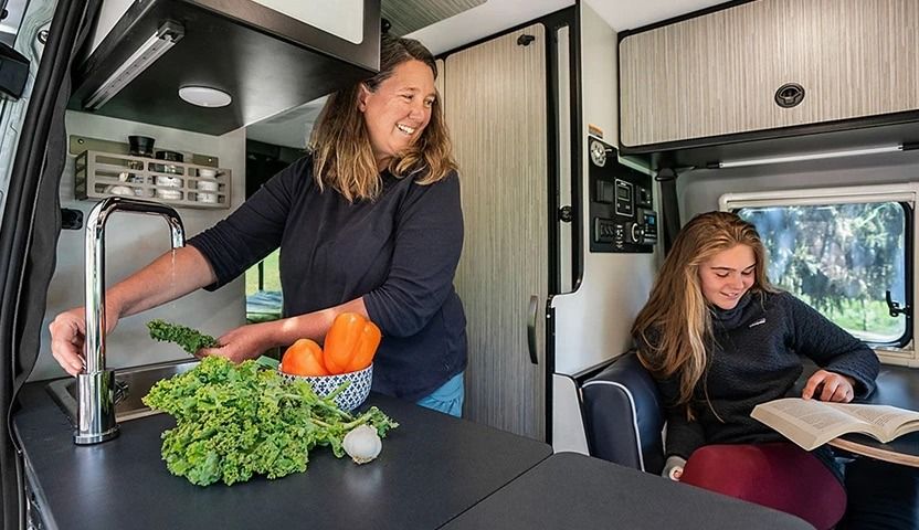 Woman and girl inside an RV