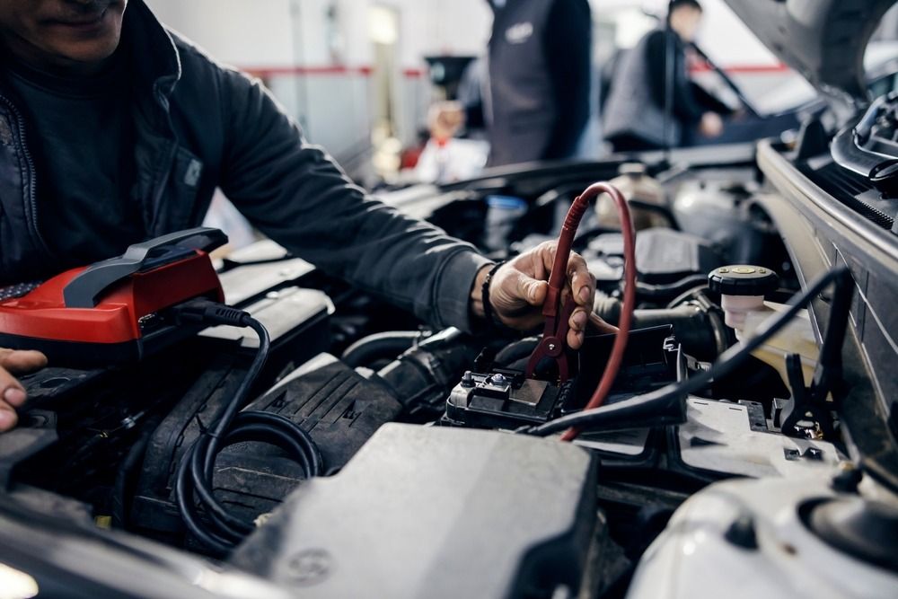 Close-up of a mechanic testing a car battery