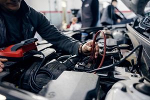 Close-up of a mechanic testing a car battery