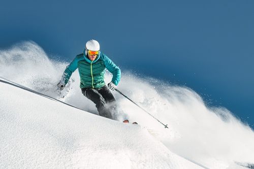 Skiier against a blue sky