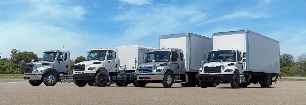 A lineup of different Freightliner trucks.