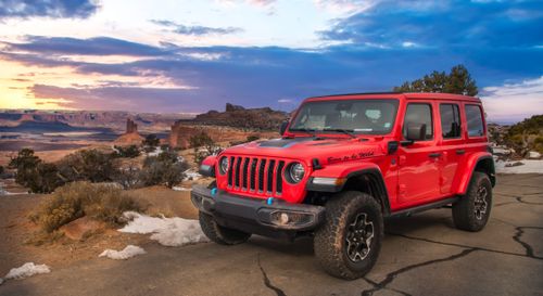 A red Jeep sits outside 