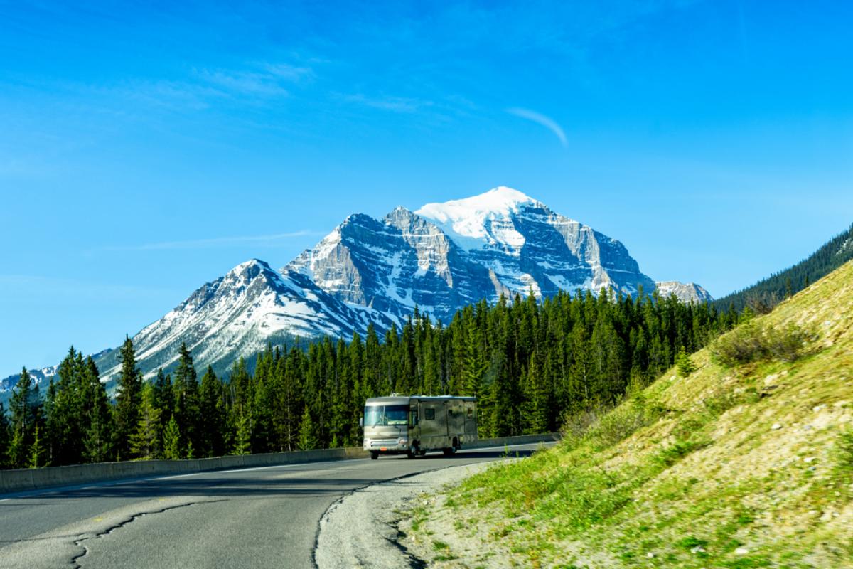 A luxury motor coach travels through Banff National Park, Canada