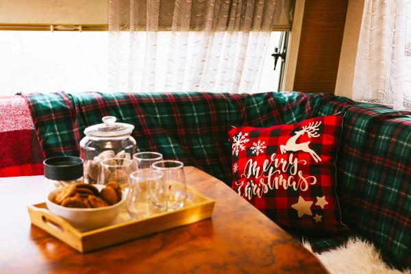 Christmas pillow, blanket, and decor inside the dining area inside an RV