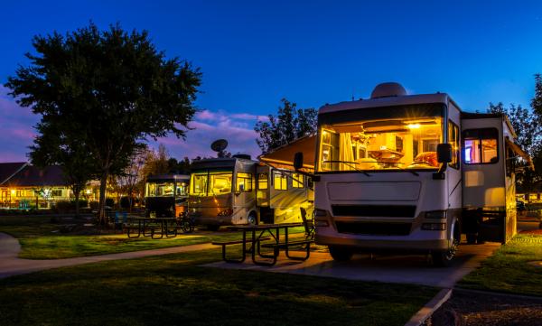 RVs parked in a campground at dusk