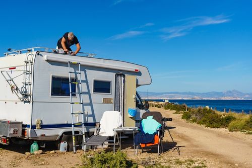 Man working on the roof of a campervan