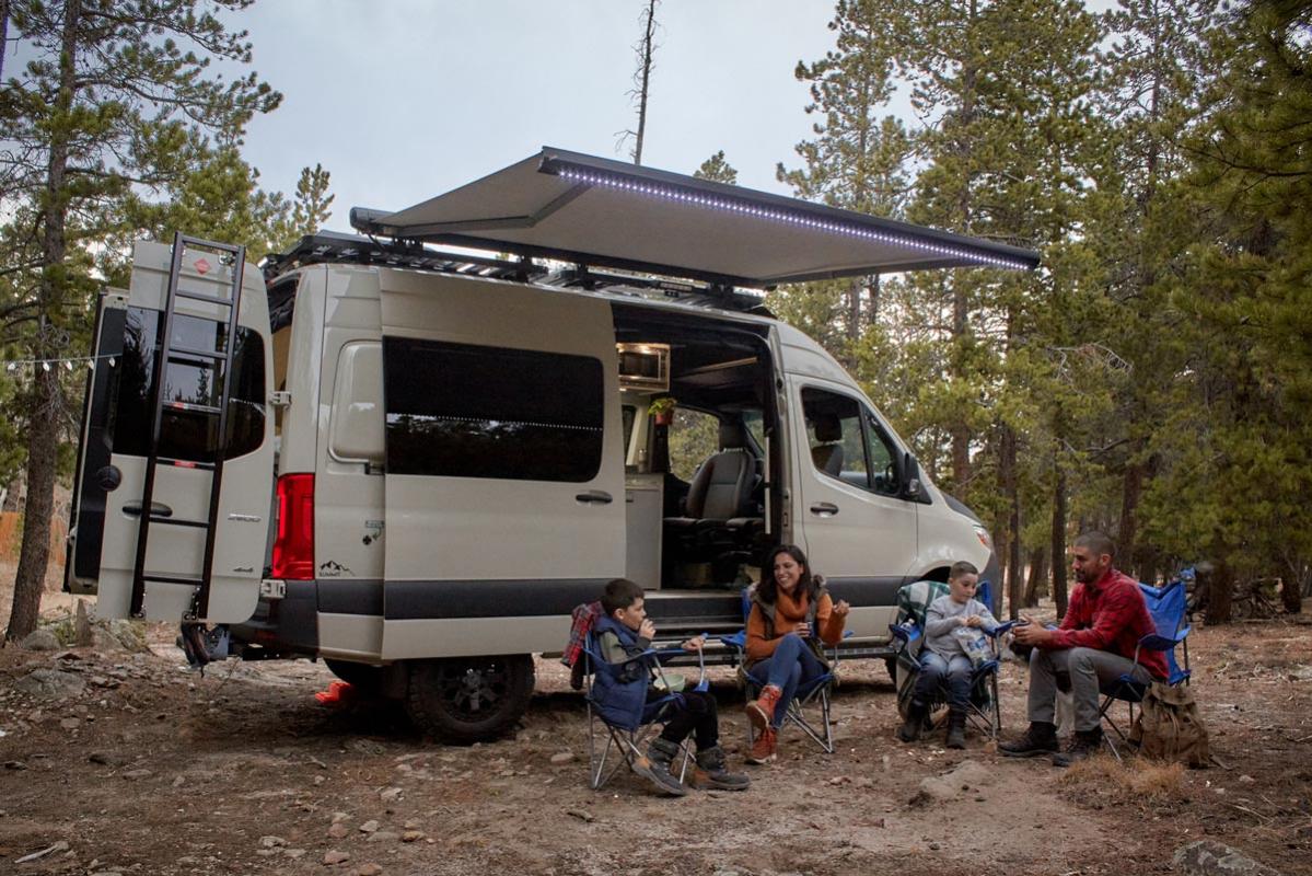 Family sitting in front of their Antero Adventure Van