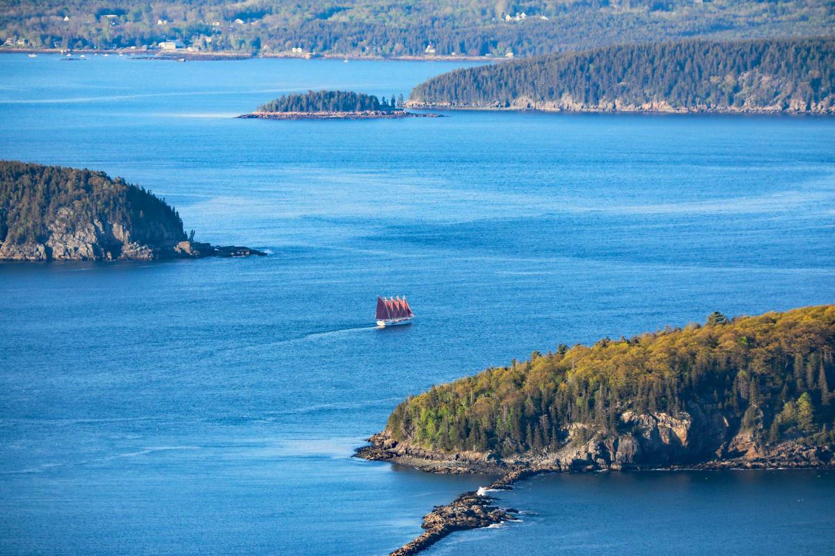 Aerial view of the water in Bar Harbor, with one ship between land masses