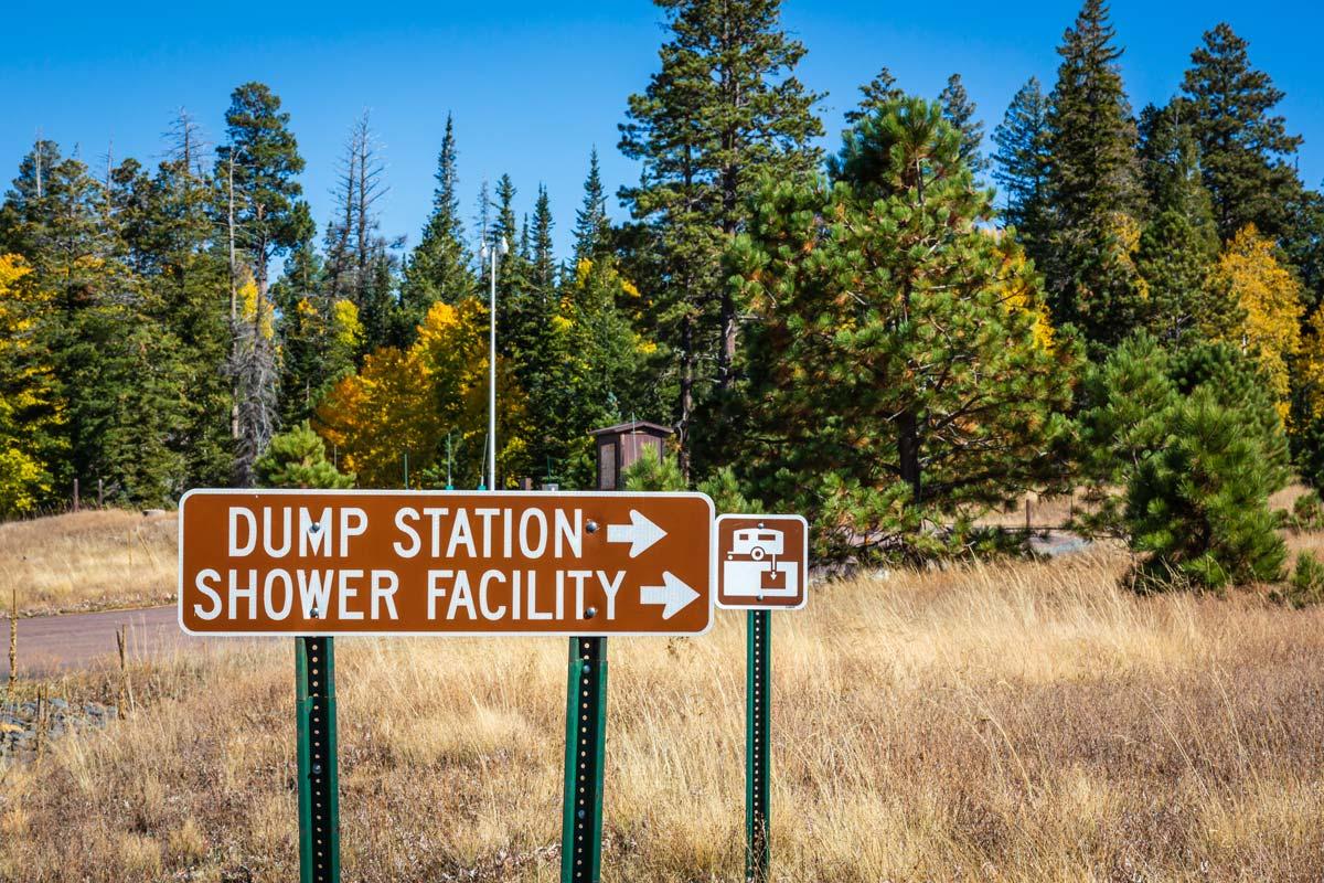 Image of a large sign pointing toward a dump station and shower facility