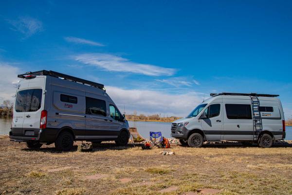 Antero Kakadu and Antero Bamaga campervans parked facing each other in front of lake