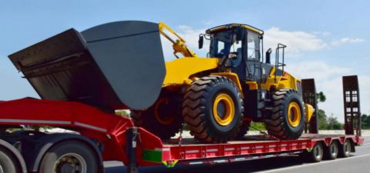 Trailer hauling large construction equipment