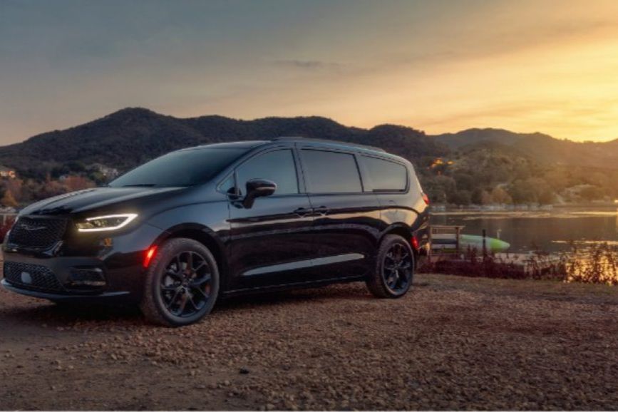 2026 Chrysler Pacifica AWD parked in front of a lakeview with sunset 