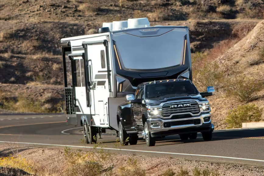 2026 Ram 3500 pickup truck with a trailer attached, showcasing its high towing capacity.