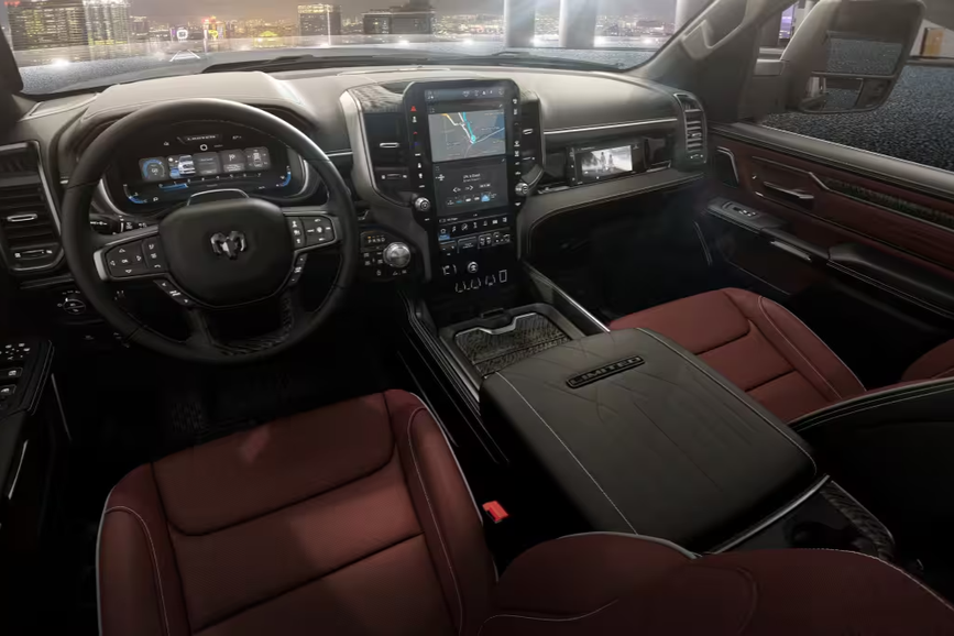 The 2026 Ram 1500 interior featuring premium cloth seats, plenty of storage compartments, and an Uconnect 8.4 in infotainment screen with Android Auto and Apple CarPlay compatibility.