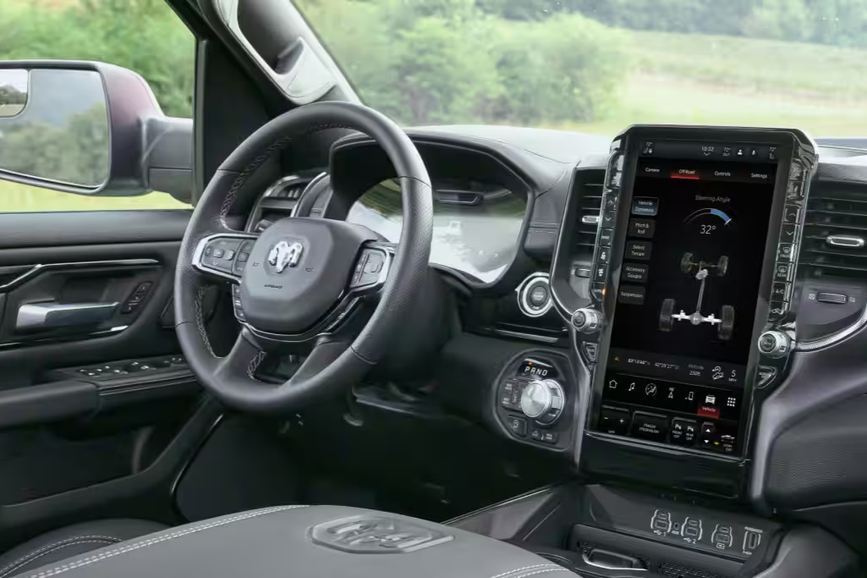Interior image of the 2026 Ram 1500 pickup featuring a large 8.4 in Uconnect infotainment screen with Ram Connect smartphone integration and other driver-assist features.
