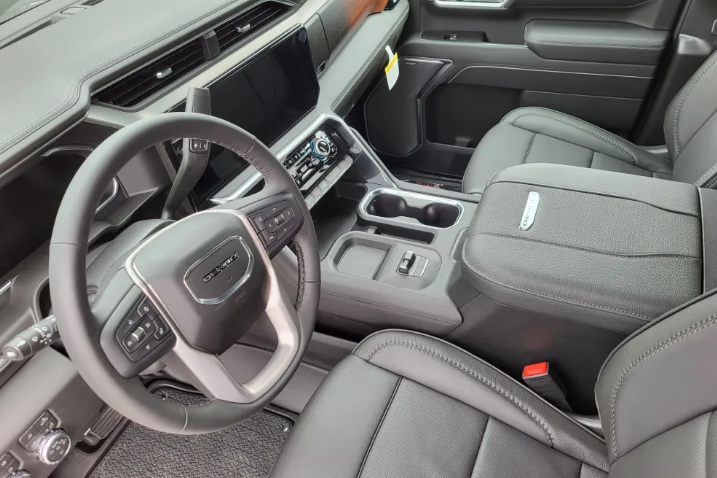2026 GMC Sierra 2500HD Denali premium leather interior with wood grain trim and GMC Denali steering wheel at Transwest GMC Henderson CO